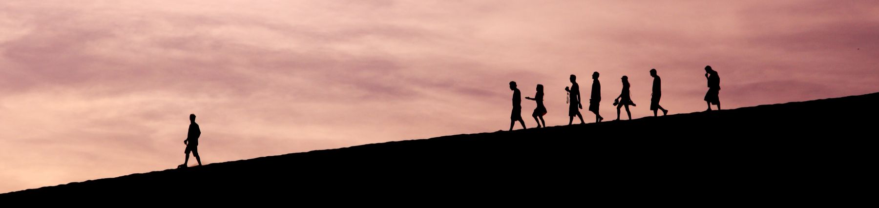 photo of people walking down a hill